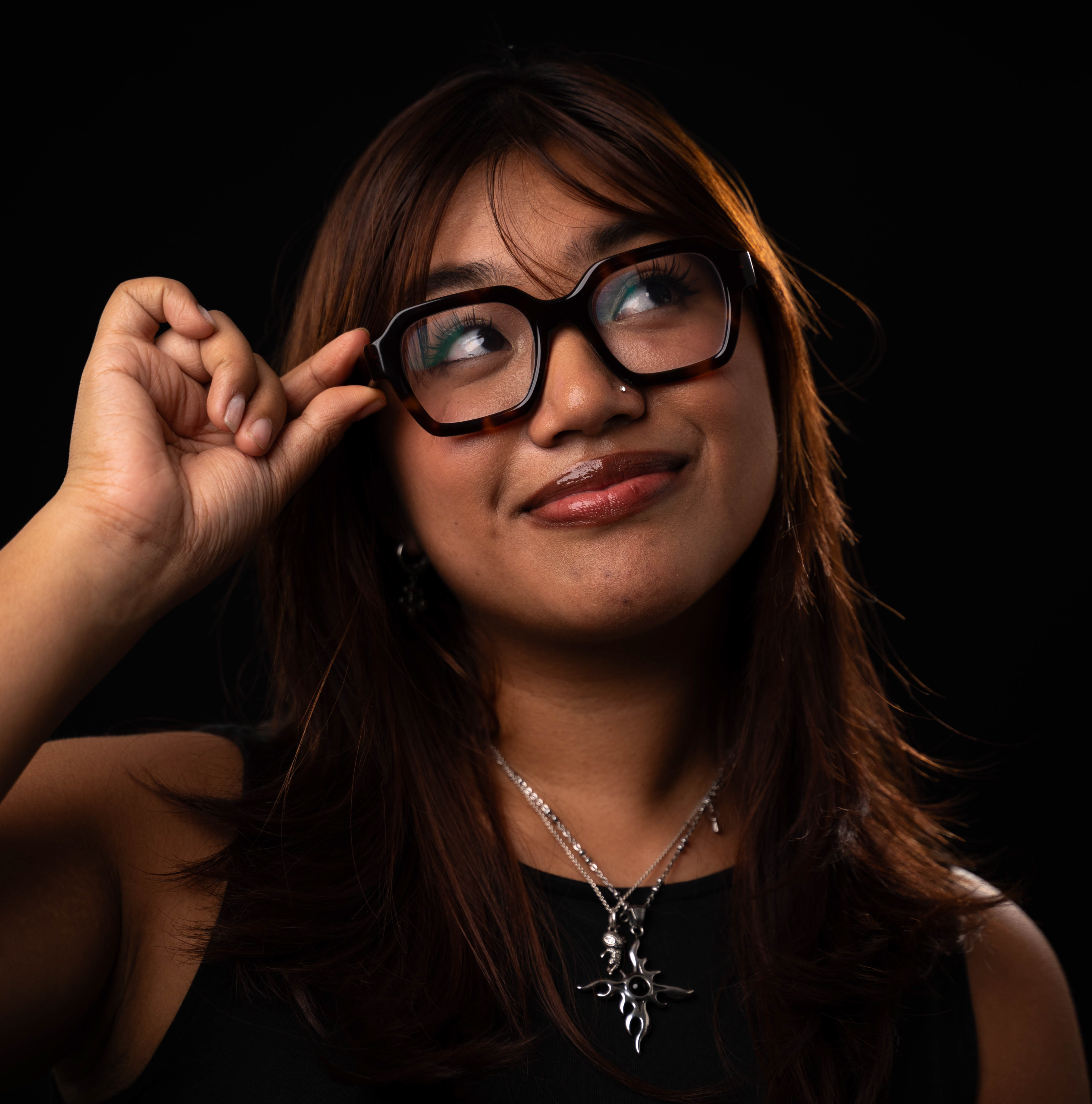 ALEXIS-HEADSHOT girl grabbing her glasses while looking up and smiling