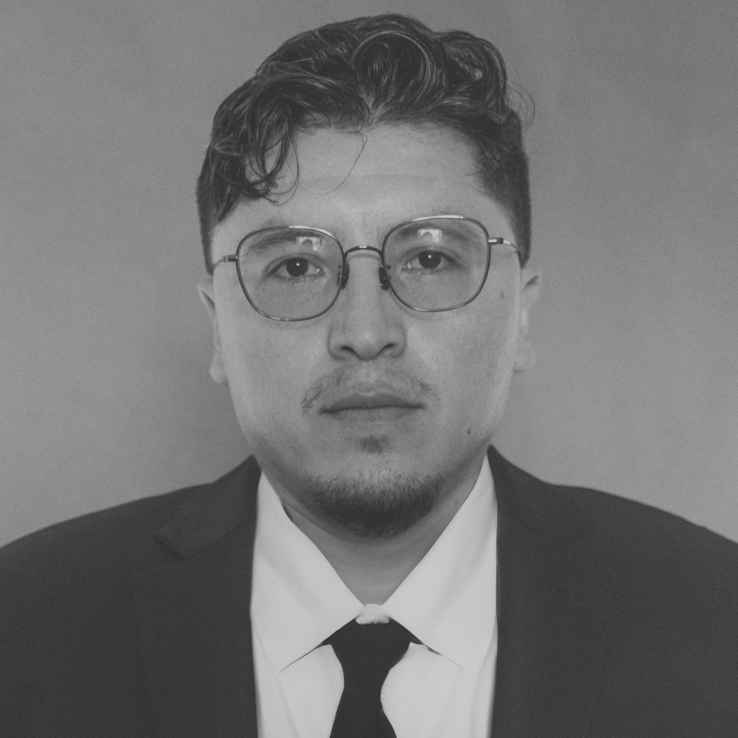 DSCF6376_headshot - Victor Zuniga 2 Photo of a man in a suit staring at the camera