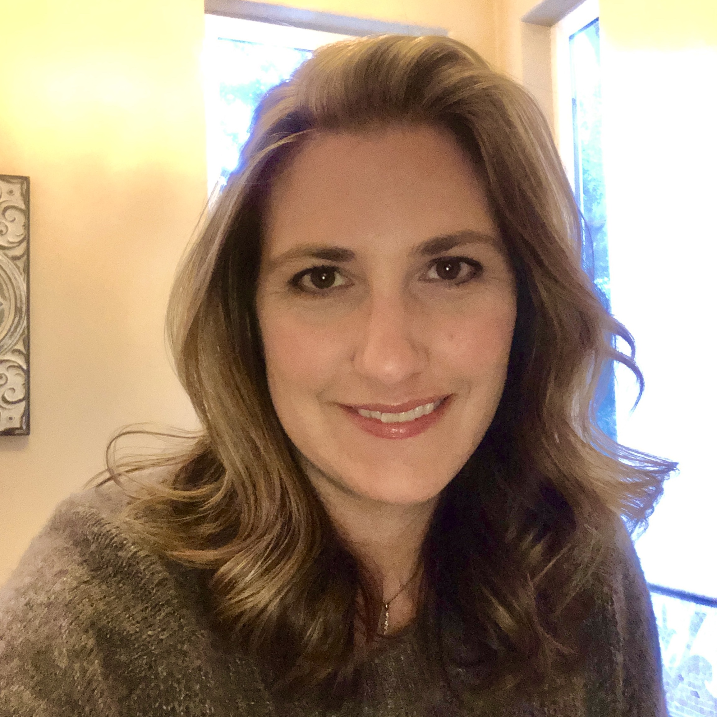 Gina headshot Selfie of woman smiling at camera