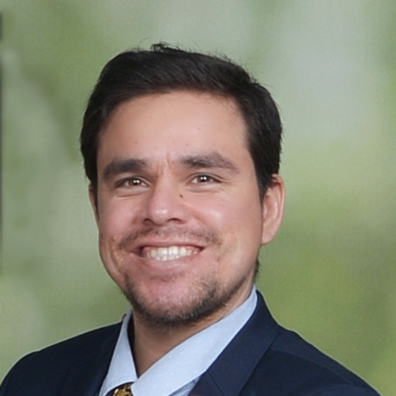 headshot - Jose Salas Photo of a man in a suit staring at the camera